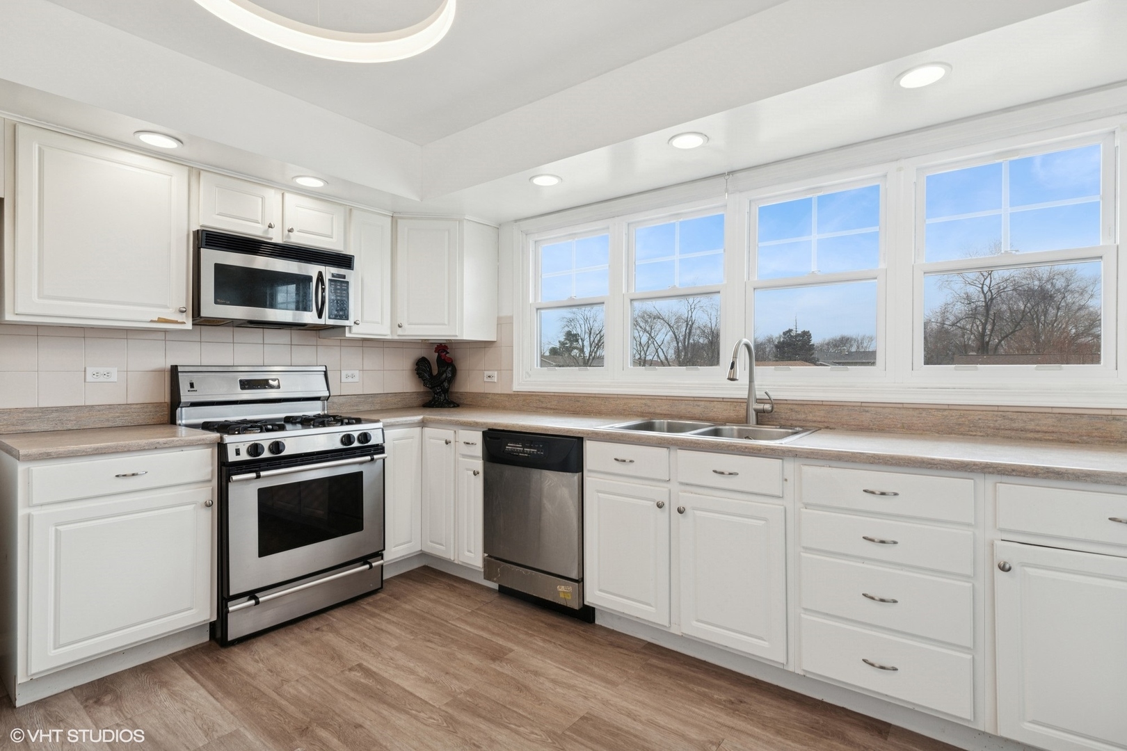 1285 Fairmont Road Hoffman Estates, IL 60169 - Photo 5 of 21 a kitchen with stainless steel appliances granite countertop a stove a sink and a microwave