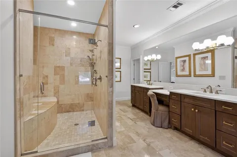 a bathroom with a granite countertop sink a toilet and a mirror