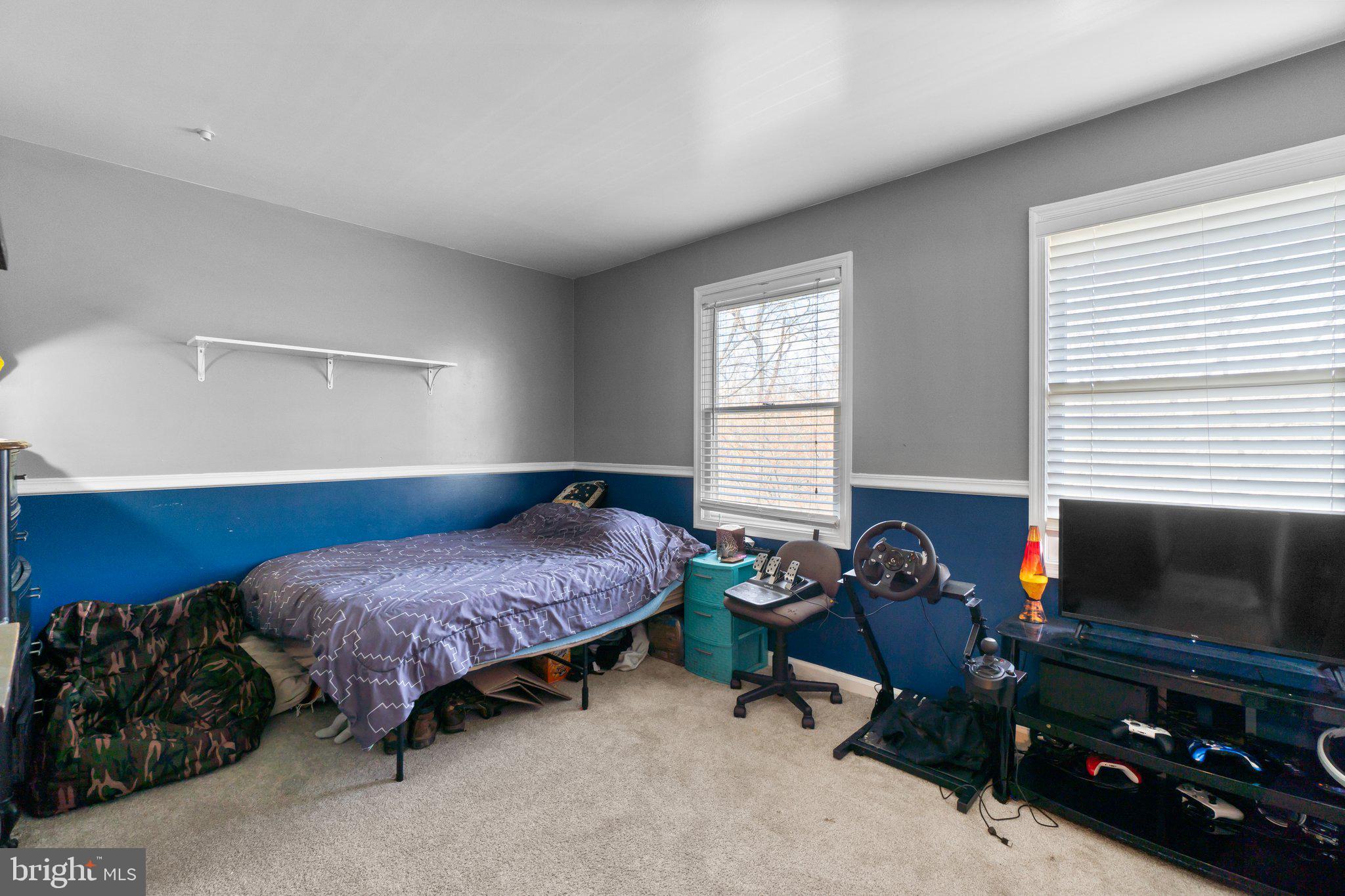 4701 Gross Mill Road Hampstead, MD 21074 - Photo 20 of 62 a bedroom with a bed a flat screen tv and a window