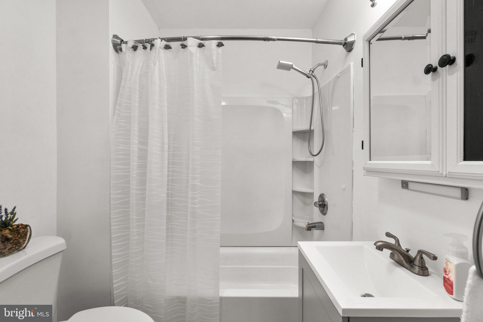 4701 Gross Mill Road Hampstead, MD 21074 - Photo 23 of 62 a bathroom with a sink and a shower curtain