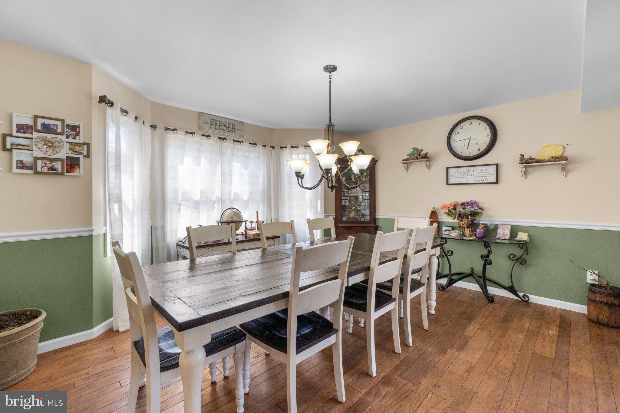 4701 Gross Mill Road Hampstead, MD 21074 - Photo 4 of 62 a view of a dining room and livingroom with furniture wooden floor a chandelier