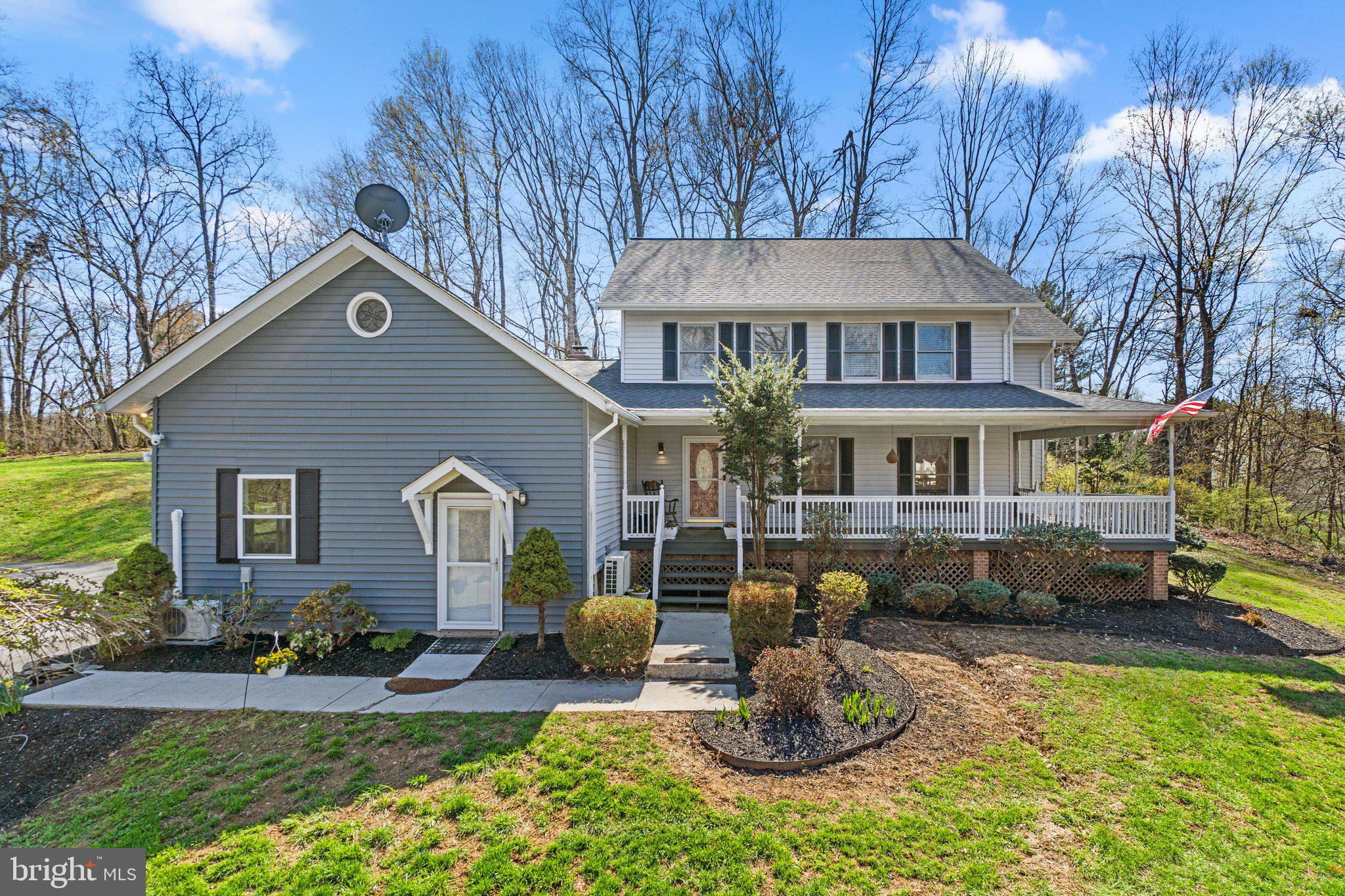4701 Gross Mill Road Hampstead, MD 21074 - Photo 52 of 62 a front view of a house with a yard outdoor seating and covered with trees