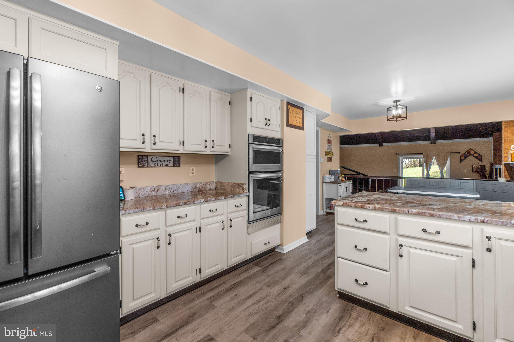 4701 Gross Mill Road Hampstead, MD 21074 - Photo 7 of 62 a kitchen with white cabinets and stainless steel appliances