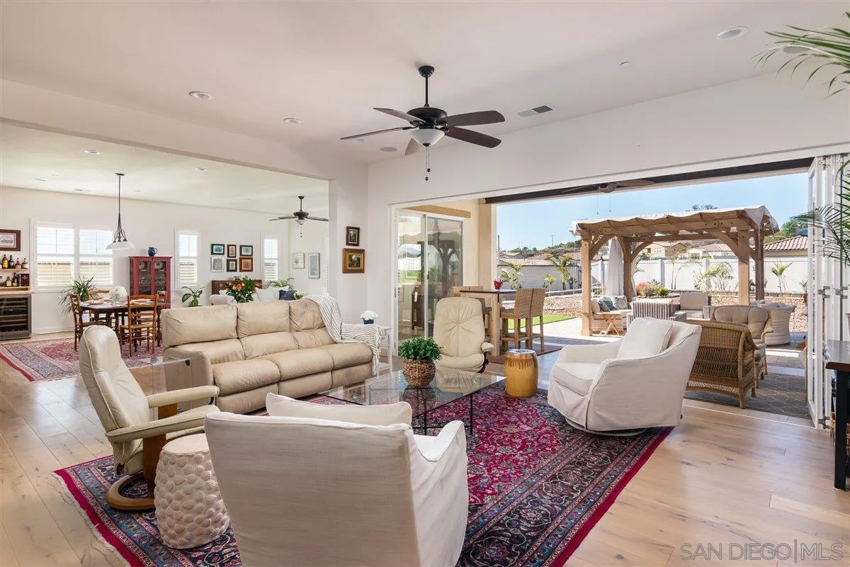 1309 Malone Court Escondido, CA 92026 - Photo 12 of 39 a living room with lots of furniture and a chandelier