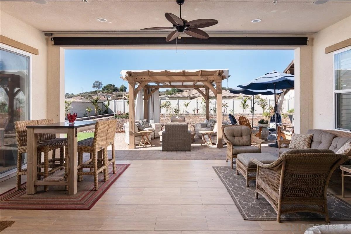 1309 Malone Court Escondido, CA 92026 - Photo 13 of 39 a living room with furniture a rug and a floor to ceiling window