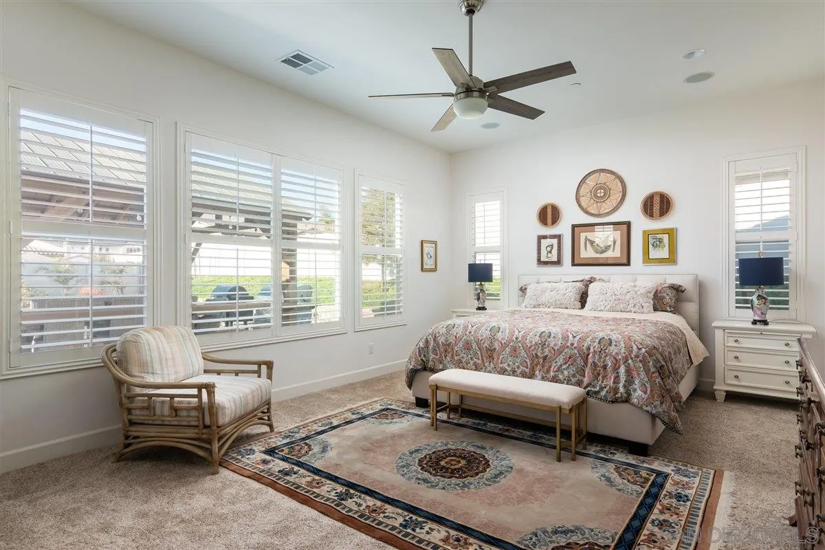 1309 Malone Court Escondido, CA 92026 - Photo 15 of 39 a spacious bedroom with a bed and a window
