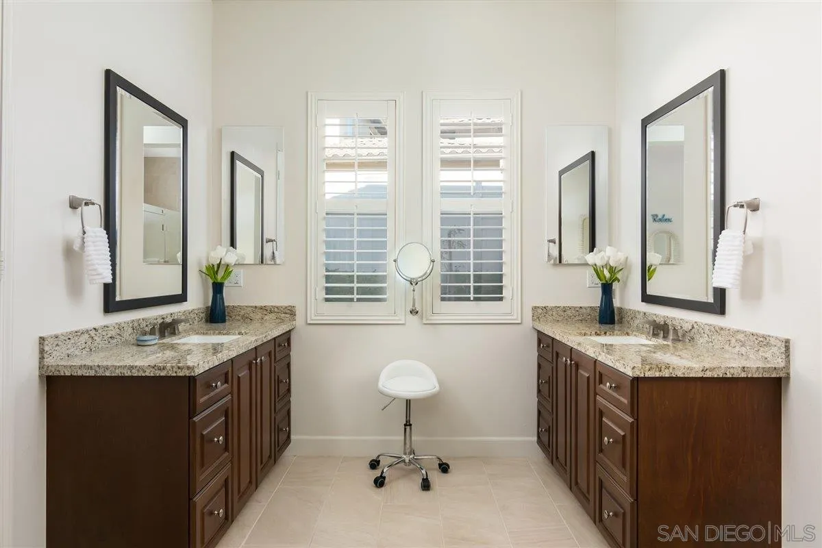 1309 Malone Court Escondido, CA 92026 - Photo 17 of 39 a bathroom with a granite countertop sink a mirror and a shower