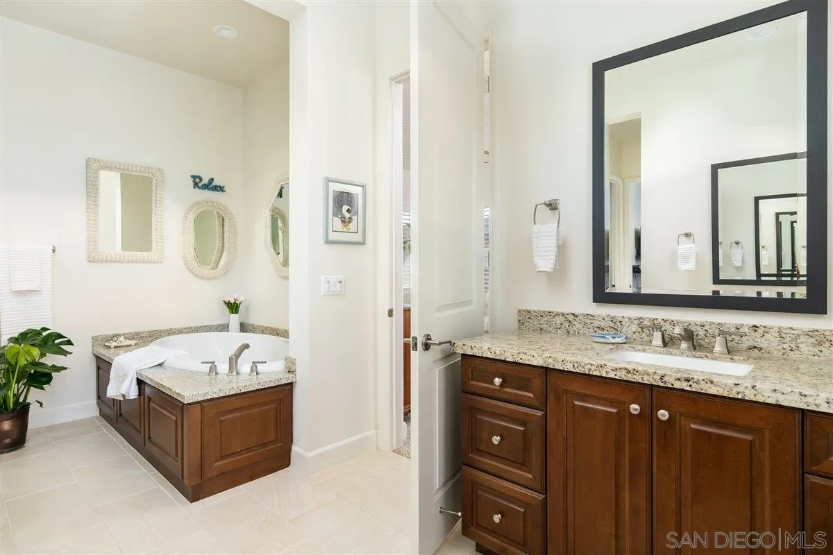 1309 Malone Court Escondido, CA 92026 - Photo 18 of 39 a bathroom with a granite countertop tub sink and mirror