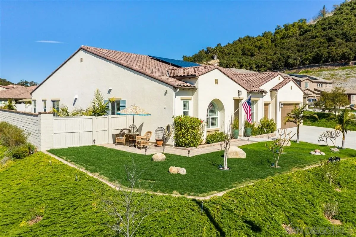 1309 Malone Court Escondido, CA 92026 - Photo 2 of 39 a view of backyard with table and chairs and potted plants
