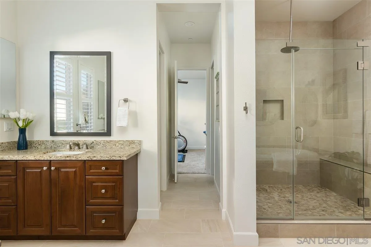 1309 Malone Court Escondido, CA 92026 - Photo 21 of 39 a bathroom with a granite countertop sink a mirror and a shower