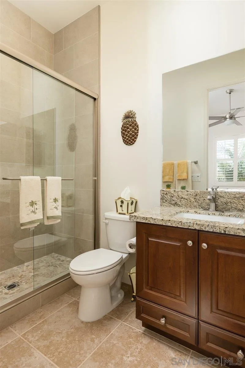 1309 Malone Court Escondido, CA 92026 - Photo 25 of 39 a bathroom with a granite countertop sink toilet and shower