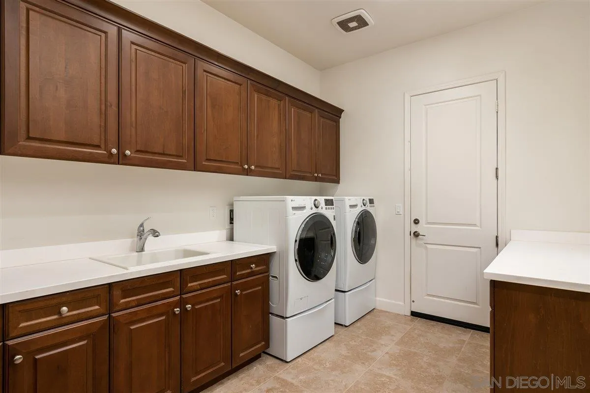 1309 Malone Court Escondido, CA 92026 - Photo 29 of 39 a utility room with sink dryer and washer
