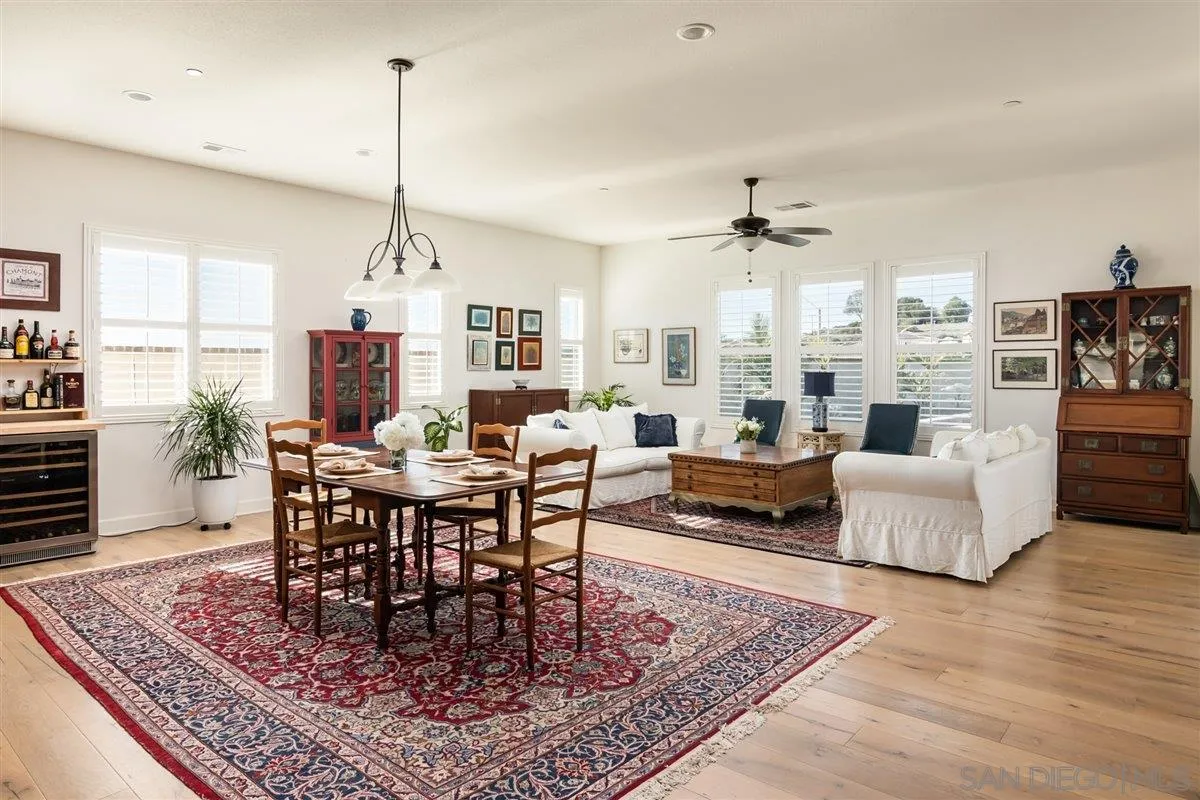 1309 Malone Court Escondido, CA 92026 - Photo 6 of 39 a view of a dining room and livingroom with furniture wooden floor a rug and a chandelier