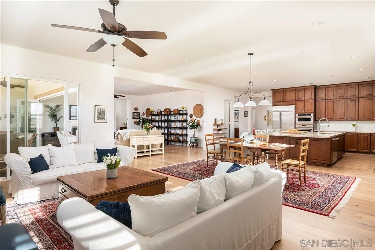 1309 Malone Court Escondido, CA 92026 - Photo 8 of 39 a living room with furniture kitchen view and a wooden floor