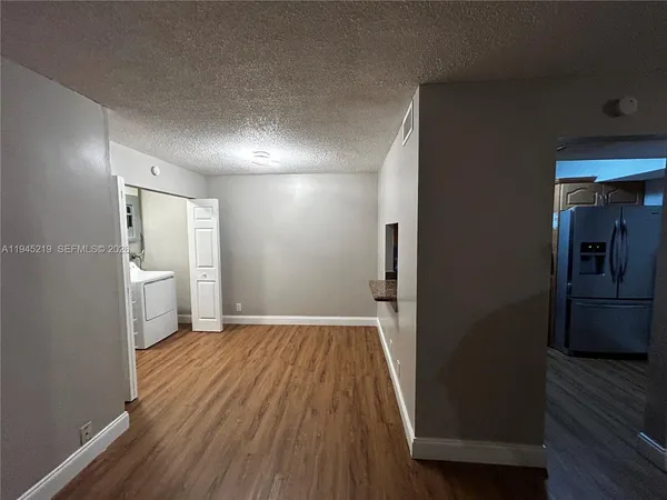a view of a hallway view with wooden floor and staircase