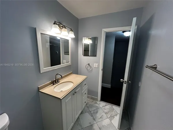 a bathroom with a sink and mirror
