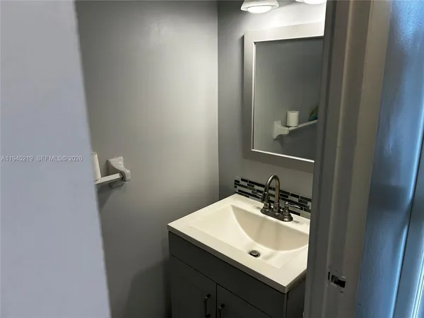 a bathroom with a sink and a mirror