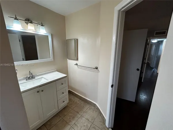 a bathroom with a double vanity sink and mirror