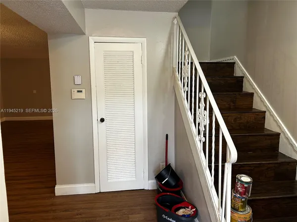 an entryway with hardwood floor and stairs