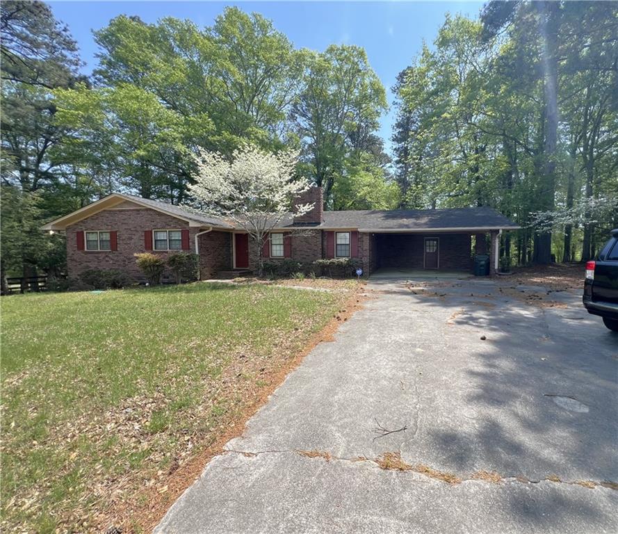 3000 Gravel Springs Road Buford, GA 30519 - Photo 4 of 6 a view of house with yard and outdoor seating