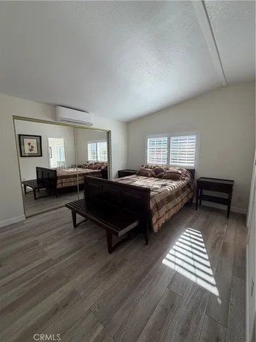 a living room with a bed furniture and a window