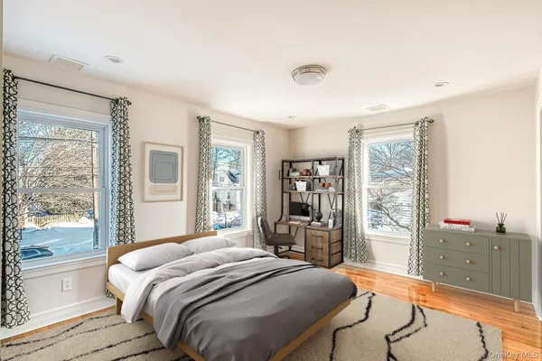 a bedroom with a bed and a chair