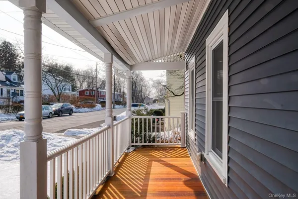 a view of a porch with wooden floor