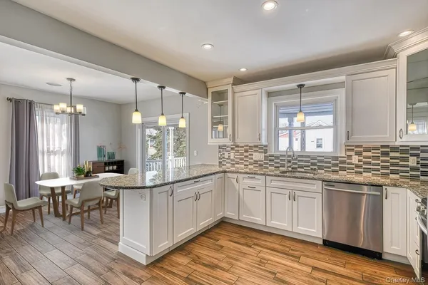 a large kitchen with a sink and cabinets