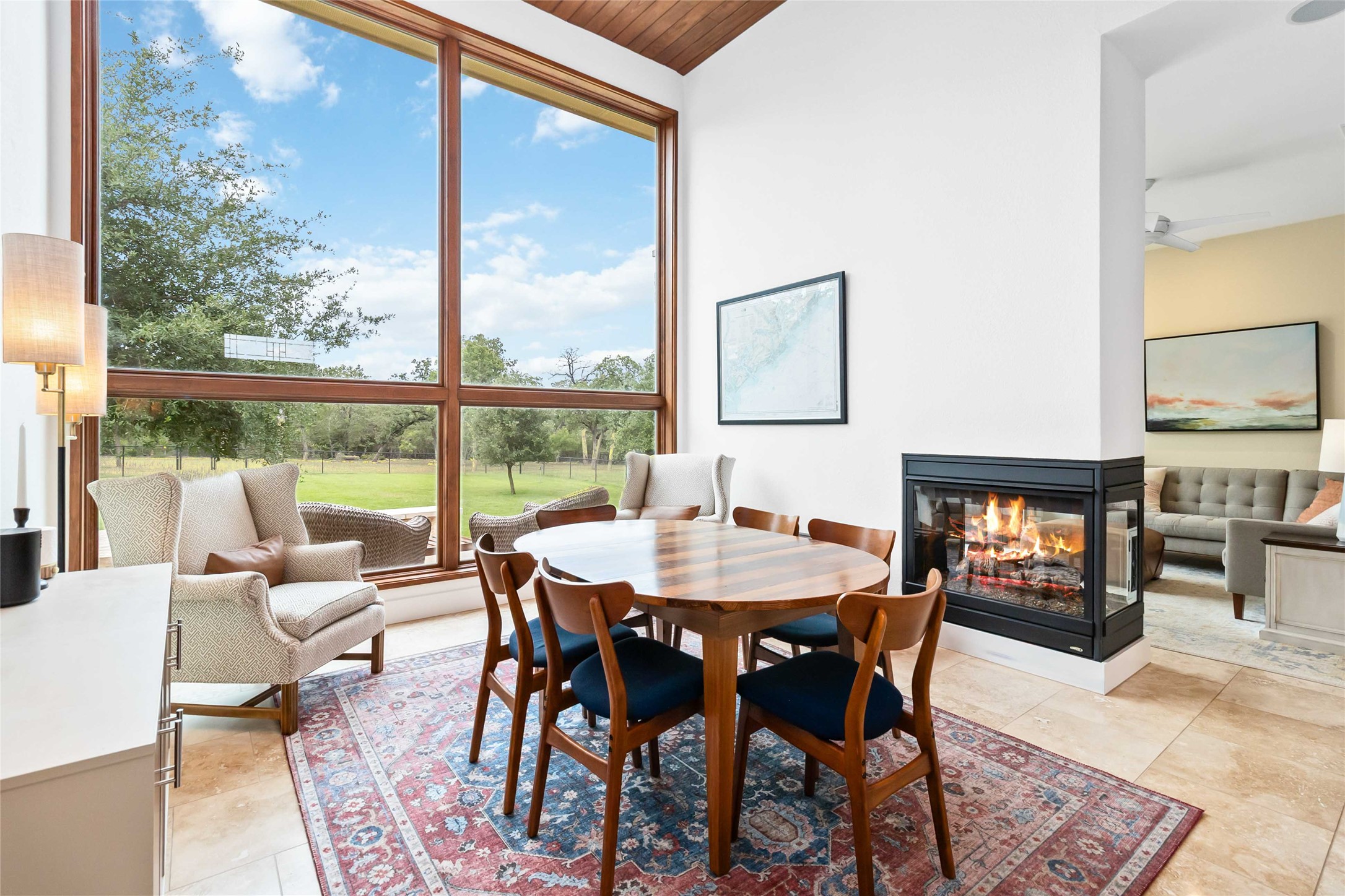 129 Powder Horn Road Bastrop, TX 78602 - Photo 6 of 27 Dining space featuring a multi sided fireplace and floor to ceiling windows