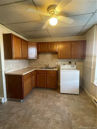 a kitchen with a stove a refrigerator and cabinets