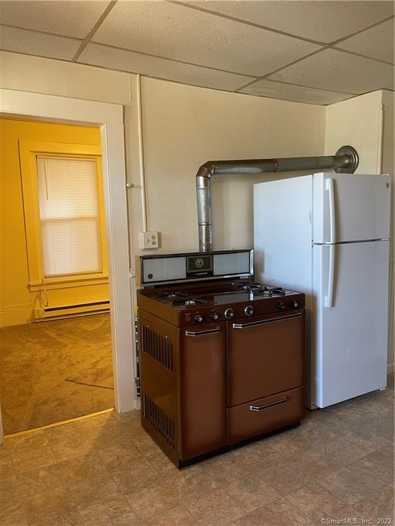 227 Howe Avenue Shelton, CT 06484 - Photo 5 of 8 a room with a stove and a refrigerator