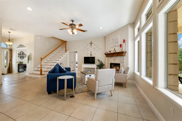 a living room with furniture a fireplace and a flat screen tv