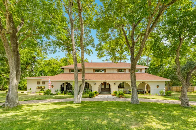 a front view of house with yard and green space