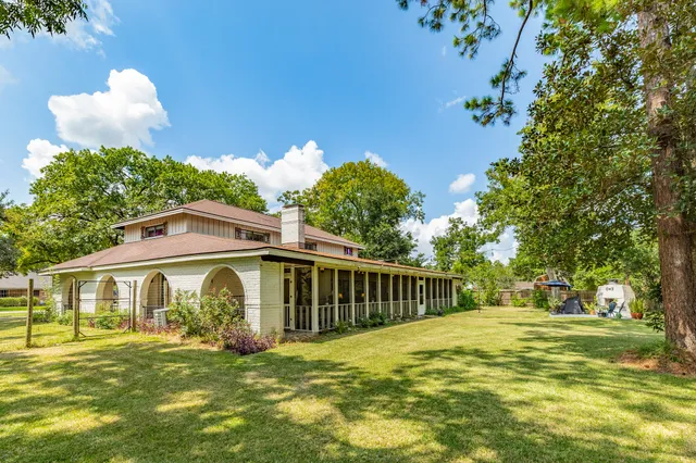a view of a house with garden and deck