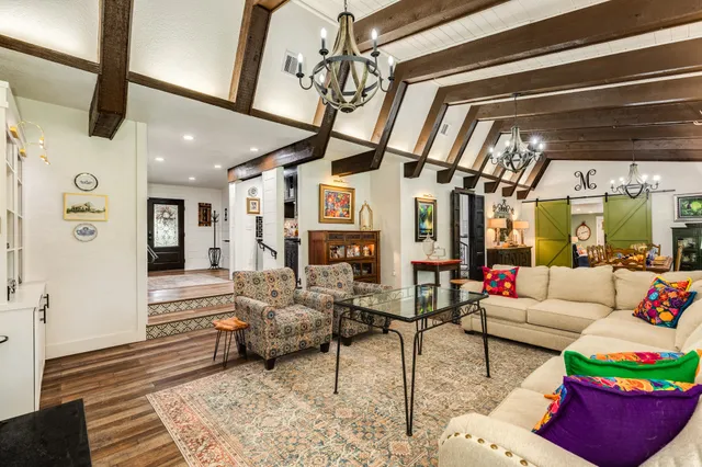 a living room with furniture and wooden floor