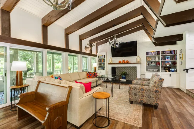 a living room with fireplace furniture and a flat screen tv