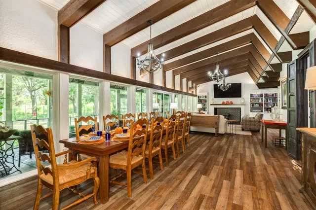 a living room with fireplace furniture and a large window