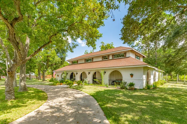 a front view of a house with garden
