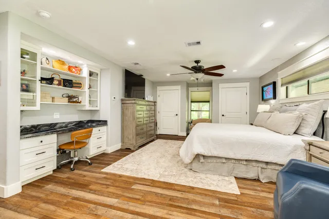 a bathroom with a toilet a sink a mirror a bathtub and shower