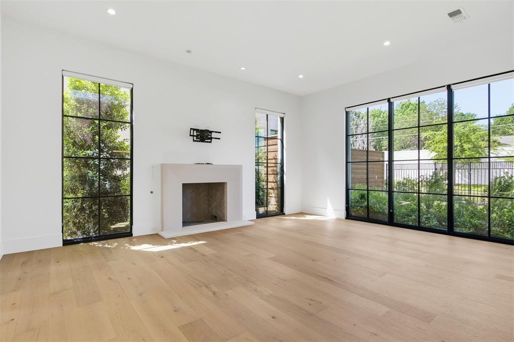 9855 Kingsway Avenue Dallas, TX 75230 - Photo 12 of 37 a view of an empty room with a fireplace and a window