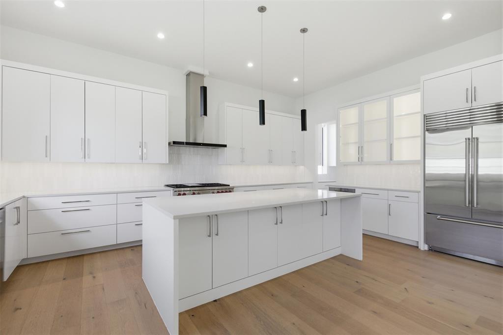9855 Kingsway Avenue Dallas, TX 75230 - Photo 16 of 37 a kitchen with white cabinets and appliances