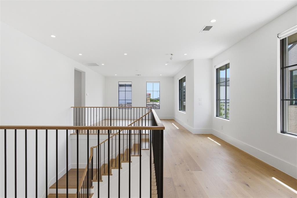 9855 Kingsway Avenue Dallas, TX 75230 - Photo 23 of 37 a view of a hallway with windows
