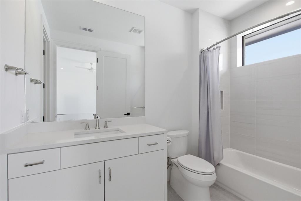 9855 Kingsway Avenue Dallas, TX 75230 - Photo 27 of 37 a view of bathroom with a sink mirror toilet and bathtub