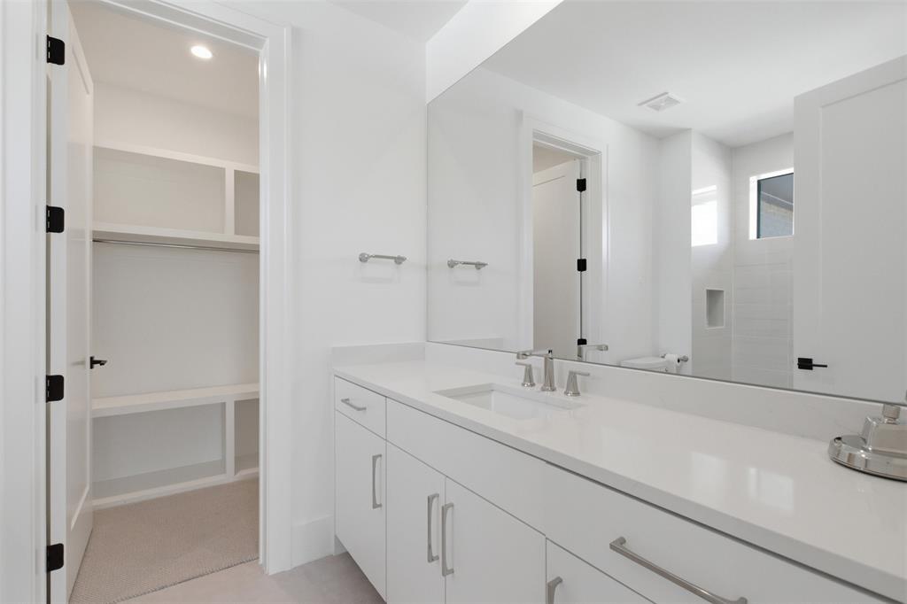 9855 Kingsway Avenue Dallas, TX 75230 - Photo 32 of 37 a bathroom with double vanity sink and a mirror