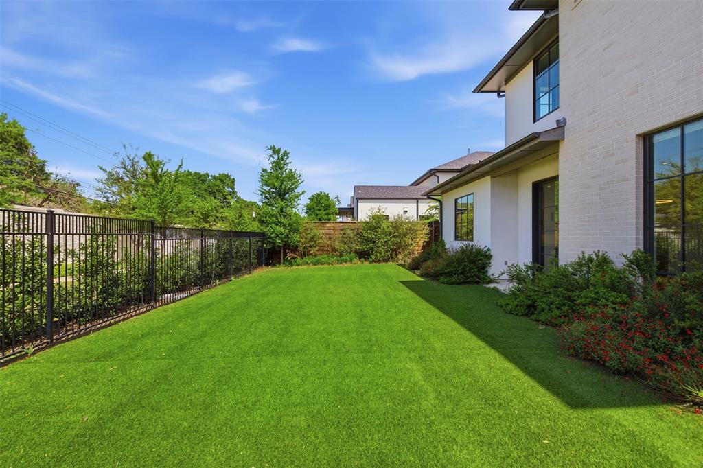 9855 Kingsway Avenue Dallas, TX 75230 - Photo 34 of 37 a view of a backyard with plants and a garden