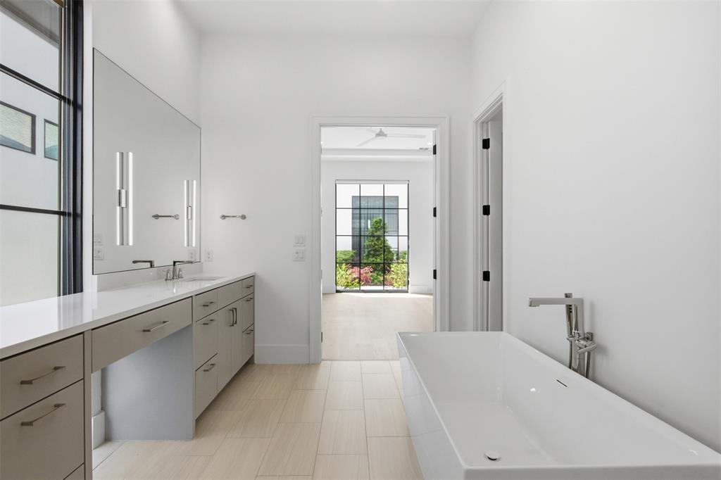 9855 Kingsway Avenue Dallas, TX 75230 - Photo 8 of 37 a spacious bathroom with a tub sink and mirror