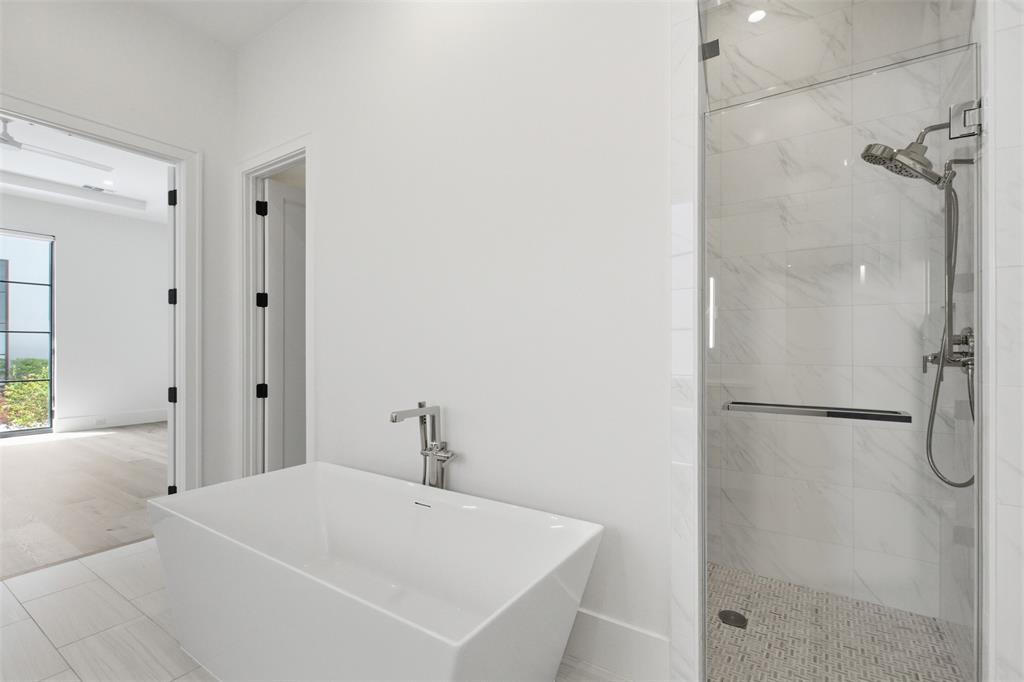 9855 Kingsway Avenue Dallas, TX 75230 - Photo 9 of 37 a white bath tub sitting next to a white sink