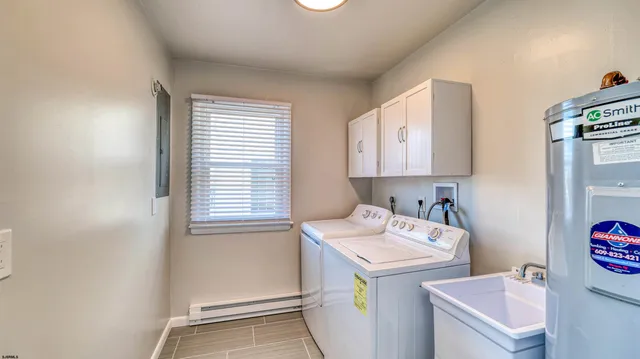 a utility room with a sink a washer and dryer