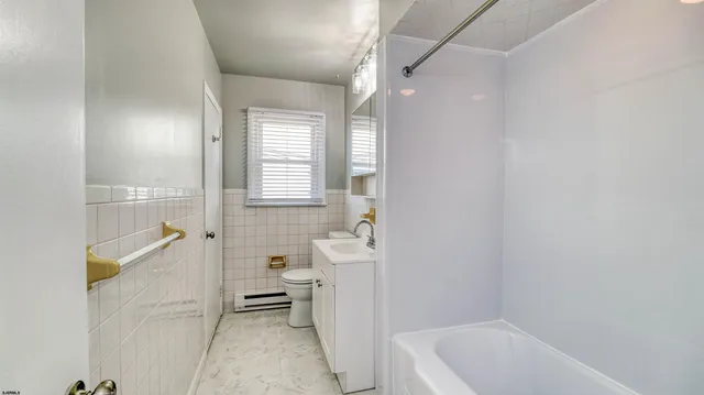 a bathroom with a bathtub sink and toilet