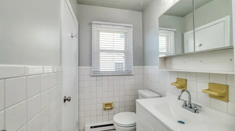 a bathroom with a sink toilet and mirror